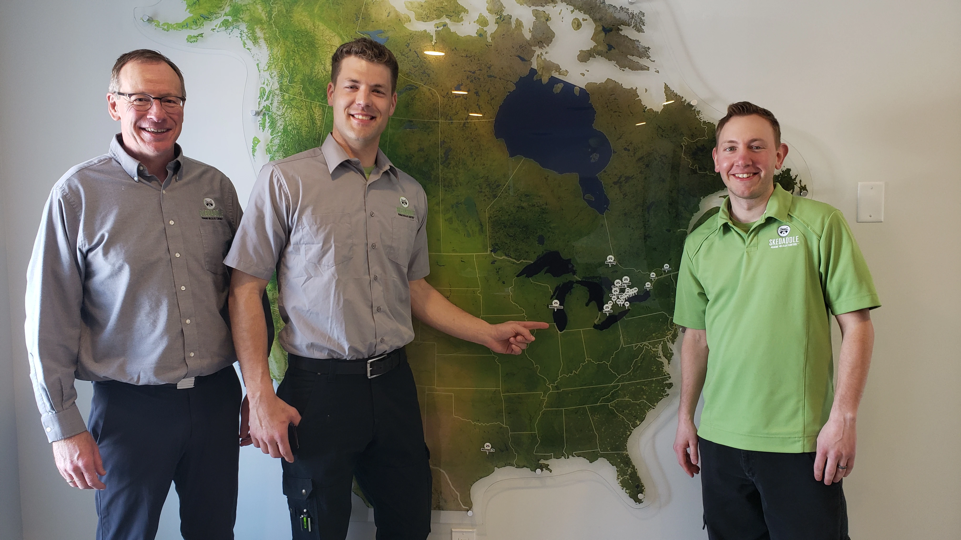 Pictured above: Bill Dowd (left), Marcus Mueller (middle) and Chris Staupe (right), Mueller's first hire, posing in front of the U.S. map.