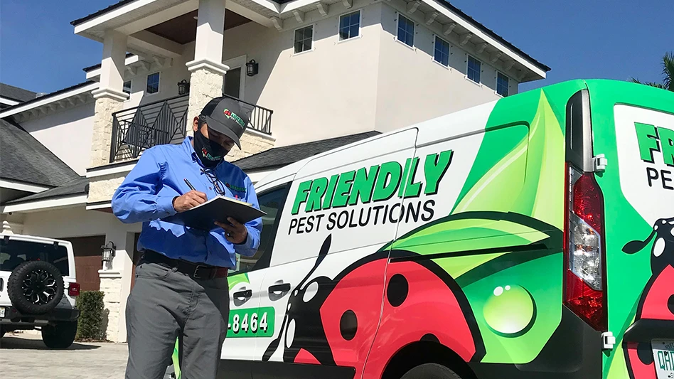 Friendly Pest service technician Ely documenting termites on a graph.