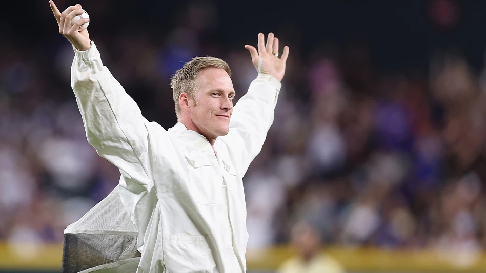 Matt Hilton reacts to fans before throwing out the ceremonial first pitch during a delay to the MLB game between the Los Angeles Dodgers and the Arizona Diamondbacks at Chase Field on April 30 in Phoenix, Ariz. The game was delayed due to a bee colony that accumulated on the net behind home plate.